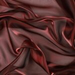 Dettaglio organza lucida rosso vinaccia - trasparenza e riflessi
